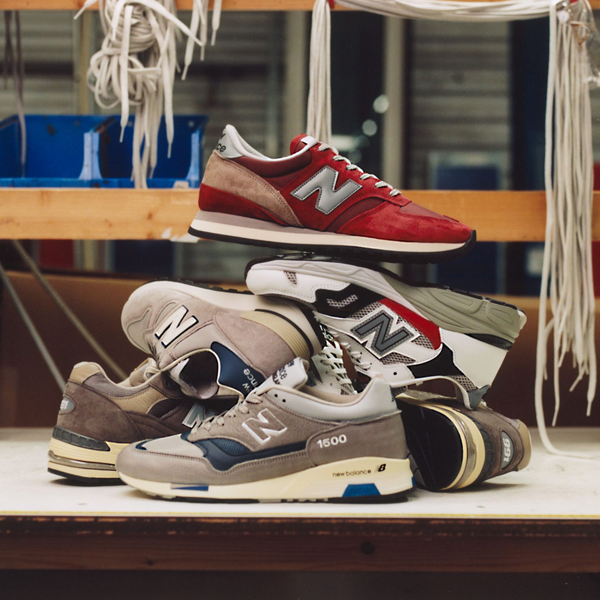 Stack of various MADE in UK shoes piled up on factory table